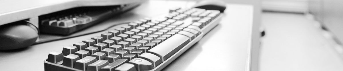 Computer keyboard and mouse on desk at Wrexham based business